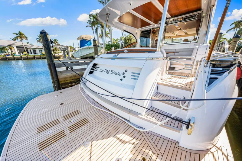 Slide: The Image of 2025 Belize 66 Daybridge yacht docked, showcasing elegant design and spacious deck. - 40