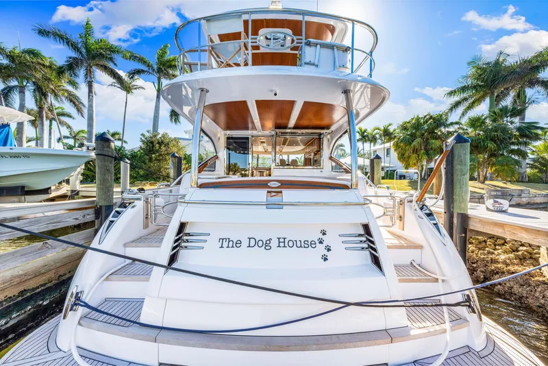 Slide: The Image of 2025 Belize 66 Daybridge yacht docked, named "The Dog House," with palm trees in the background. - 41