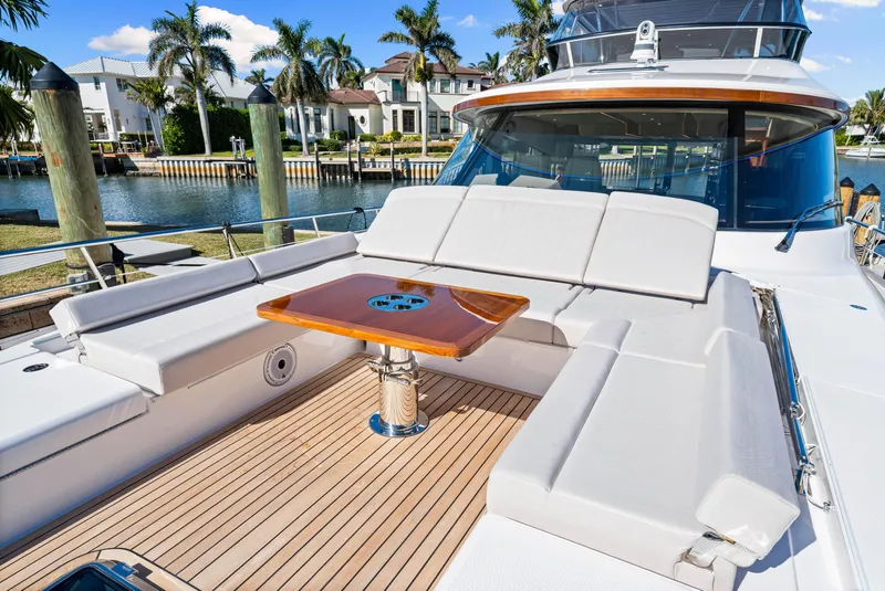 Slide: The Image of 2025 Belize 66 Daybridge yacht with luxurious deck seating and wooden table. - 45