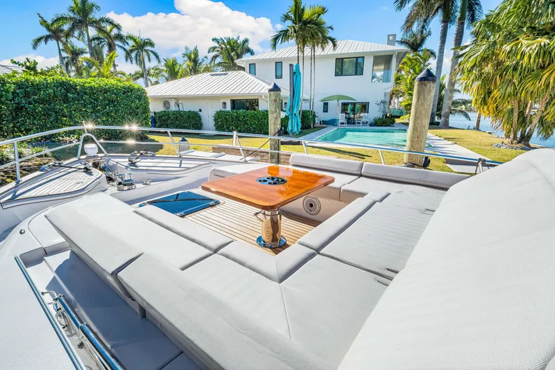 Slide: The Image of Luxurious 2025 Belize 66 Daybridge yacht with sun deck, docked near waterfront property. - 46