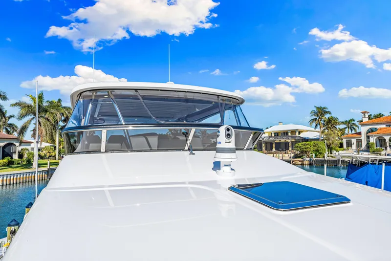 Slide: The Image of 2025 Belize 66 Daybridge yacht, sleek design, docked under clear blue sky. - 47