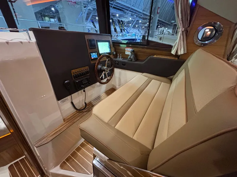 Slide: The Image of 2025 Ranger Tugs R-29 S interior with modern helm and comfortable seating. - 16