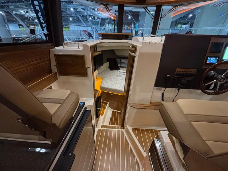 Slide: The Image of Interior of 2025 Ranger Tugs R-29 S boat, featuring modern seating and wood accents. - 17