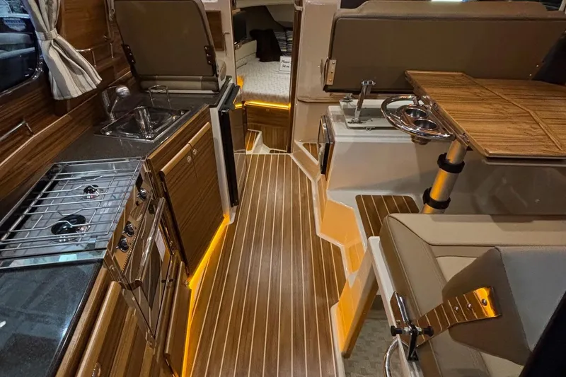 Slide: The Image of Interior of 2025 Ranger Tugs R-29 S, featuring elegant wood finishes and modern amenities. - 21