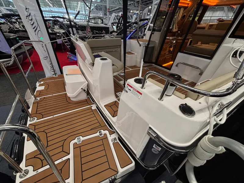 Slide: The Image of 2025 Ranger Tugs R-29 S boat interior with teak flooring and modern seating. - 3