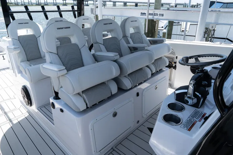 Slide: The Image of 2025 Twin Vee 400 GFX2 CC boat interior with luxurious white seating and modern controls. - 15