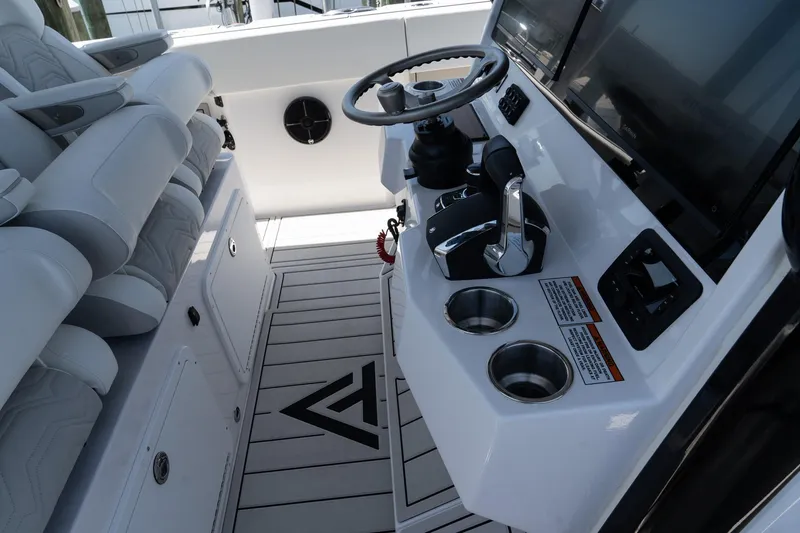 Slide: The Image of 2025 Twin Vee 400 GFX2 CC boat cockpit with steering wheel and controls. - 22