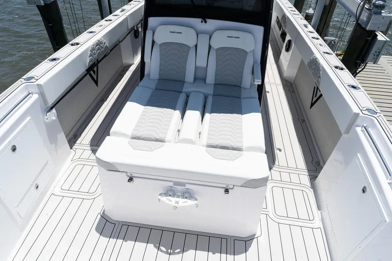 Slide: The Image of 2025 Twin Vee 400 GFX2 CC boat interior with white seating and sleek design. - 27