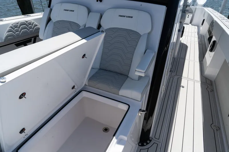 Slide: The Image of 2025 Twin Vee 400 GFX2 CC boat interior with seating and storage compartment. - 29