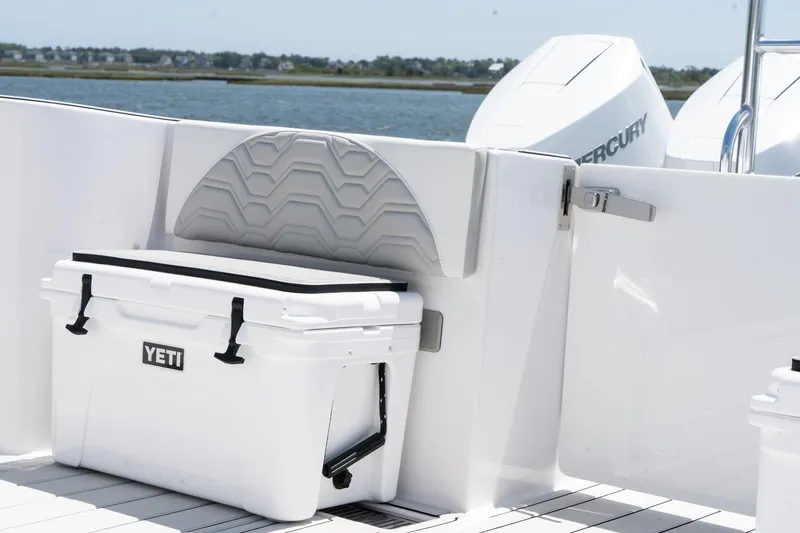Slide: The Image of 2025 Twin Vee 400 GFX2 CC boat with Yeti cooler on deck, near water. - 40