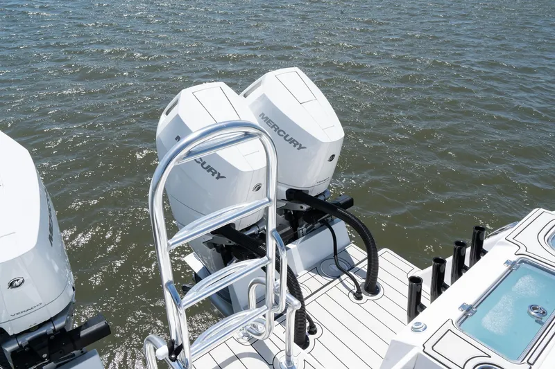 Slide: The Image of Twin Vee 400 GFX2 CC 2025 boat with dual Mercury outboard engines on water. - 42