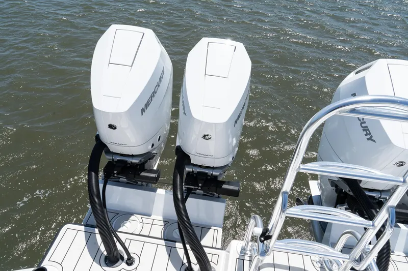 Slide: The Image of Twin Vee 400 GFX2 CC 2025 boat with dual Mercury outboard engines on water. - 44