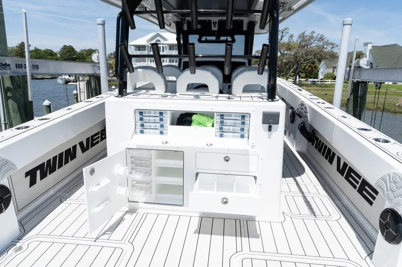 Slide: The Image of 2025 Twin Vee 400 GFX2 CC boat interior with storage compartments and seating. - 48
