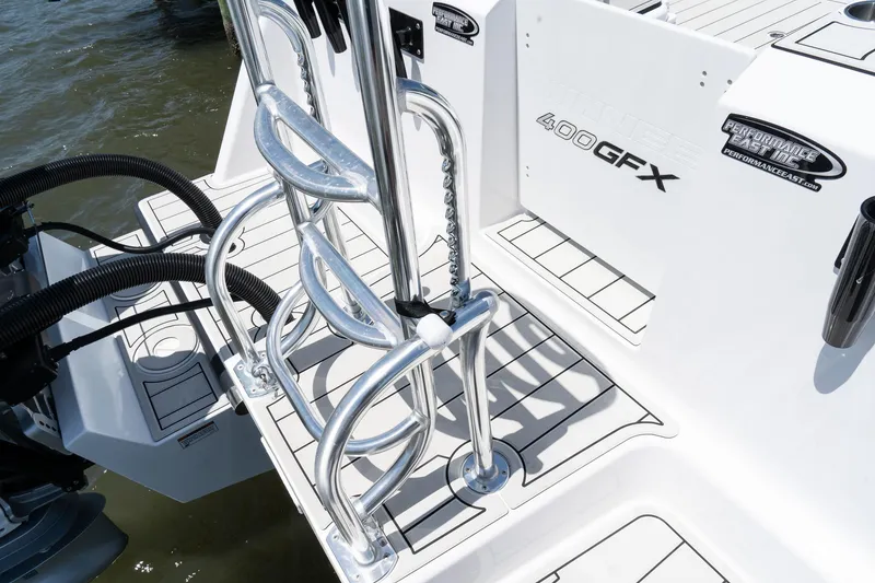 Slide: The Image of 2025 Twin Vee 400 GFX2 CC boat deck with ladder and branding details. - 9