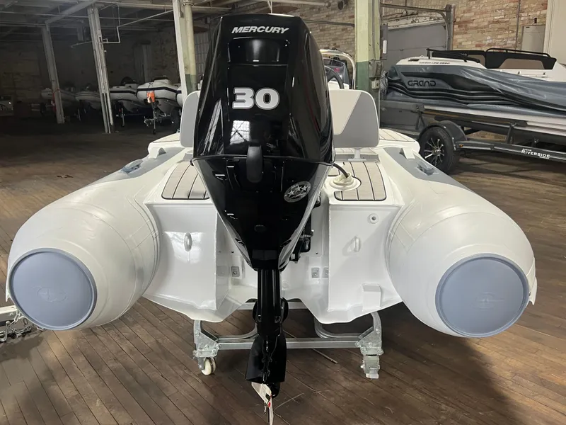 Slide: The Image of 2023 Gala V330 inflatable boat with Mercury 30 outboard motor in a warehouse setting. - 8
