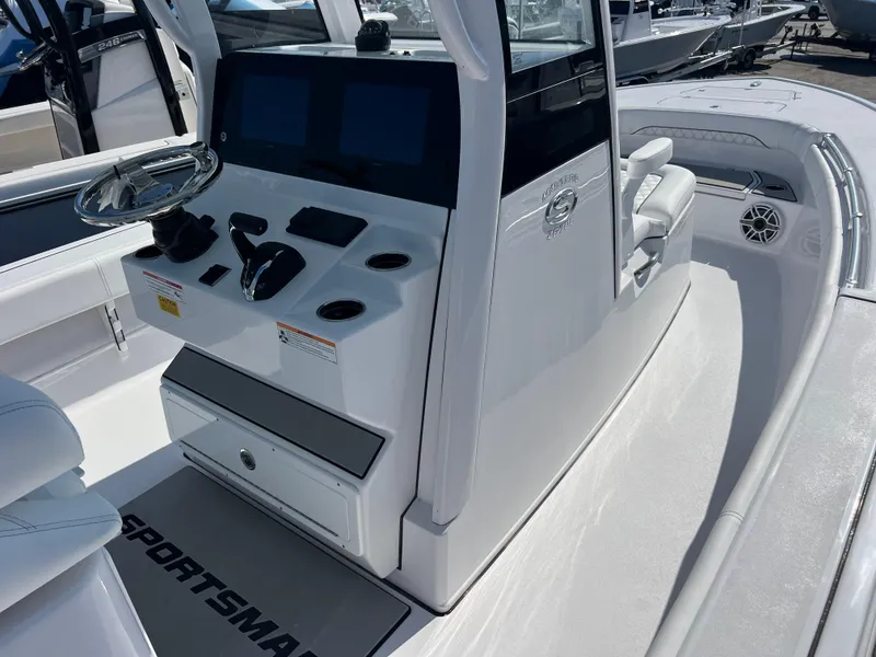 Slide: The Image of 2025 Sportsman Masters 267OE Bay Boat cockpit with modern controls and dual screens. - 10