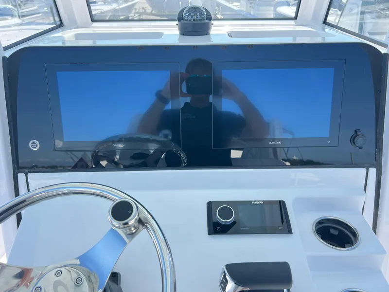 Slide: The Image of 2025 Sportsman Masters 267OE Bay Boat dashboard with dual screens and steering wheel. - 12