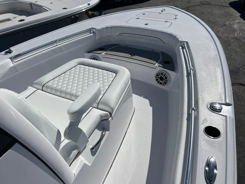 Slide: The Image of 2025 Sportsman Masters 267OE Bay Boat interior with white seating and modern design. - 13