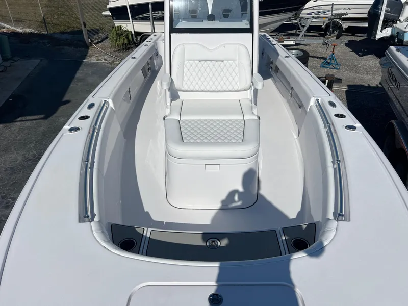 Slide: The Image of 2025 Sportsman Masters 267OE Bay Boat with white seating and spacious deck. - 14