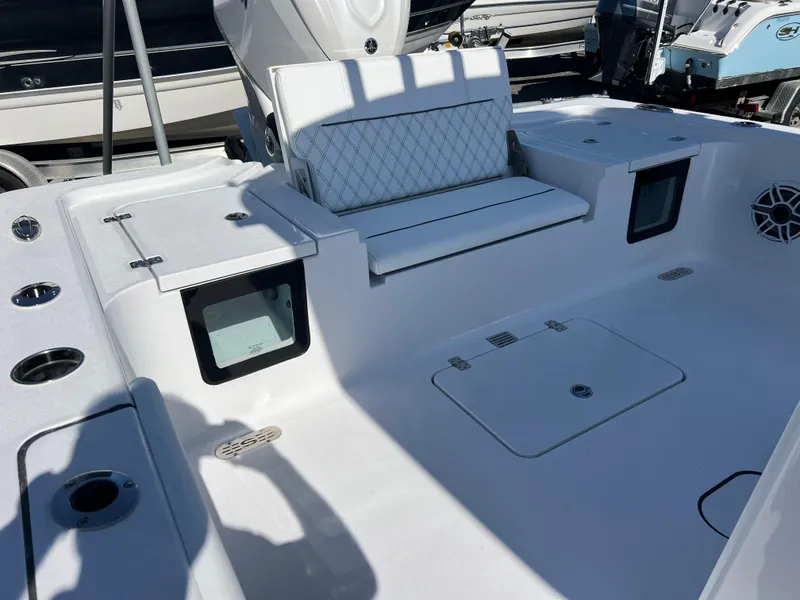 Slide: The Image of 2025 Sportsman Masters 267OE Bay Boat interior with seating and storage compartments. - 18