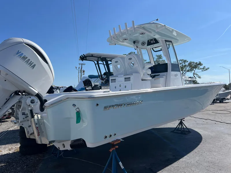 Slide: The Image of 2025 Sportsman Masters 267OE Bay Boat with Yamaha engine, displayed outdoors. - 3