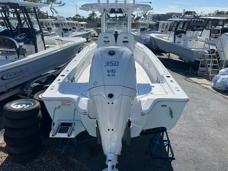 Slide: The Image of 2025 Sportsman Masters 267OE Bay Boat with 350 V6 engine, displayed in a marina. - 4