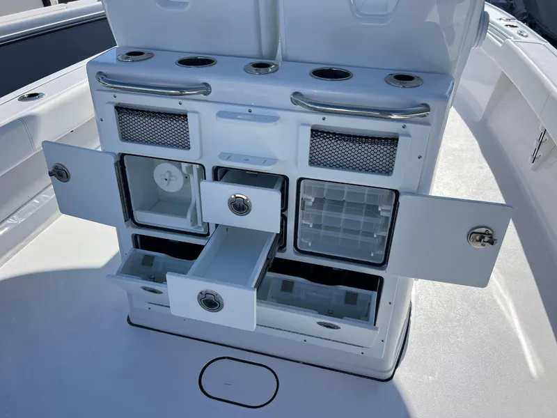 Slide: The Image of 2025 Sportsman Masters 267OE Bay Boat console with storage compartments and cup holders. - 9