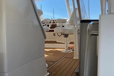 Slide: The Image of 2002 Silverton 453 Motor Yacht interior with helm and seating, featuring teak flooring. - 13