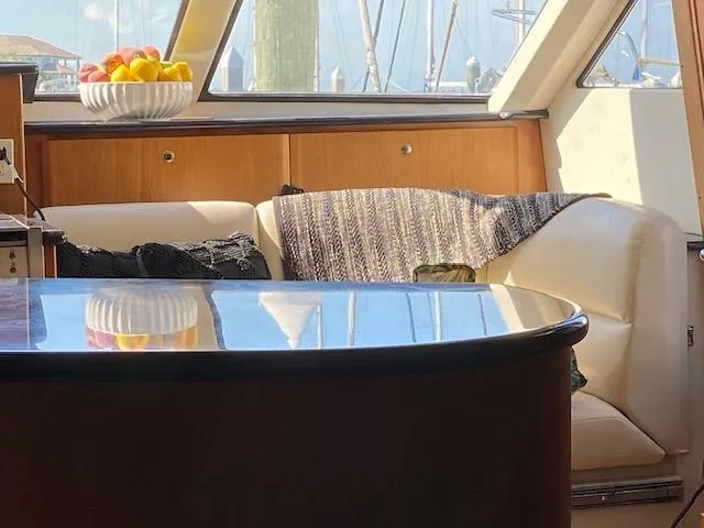 Slide: The Image of Interior of 2002 Silverton 453 Motor Yacht with cozy seating and fruit bowl. - 14