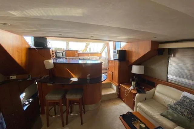 Slide: The Image of Interior of 2002 Silverton 453 Motor Yacht with cozy seating and bar area. - 15