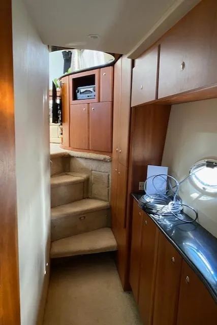 Slide: The Image of Interior of 2002 Silverton 453 Motor Yacht with wooden cabinetry and carpeted stairs. - 21