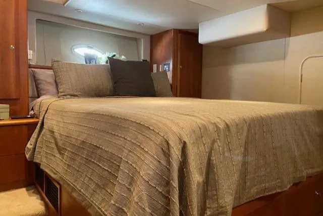 Slide: The Image of Interior of 2002 Silverton 453 Motor Yacht with cozy bed and wooden cabinetry. - 22