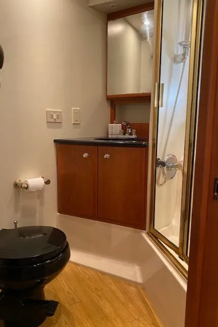 Slide: The Image of Bathroom interior of 2002 Silverton 453 Motor Yacht with shower and wooden cabinetry. - 24