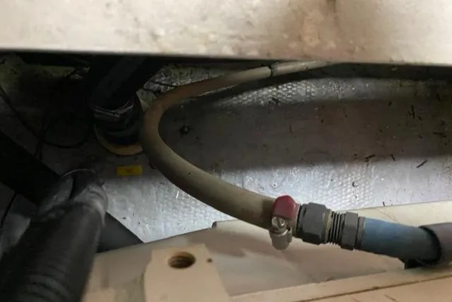 Slide: The Image of Engine compartment of a 2002 Silverton 453 Motor Yacht showing hoses and fittings. - 30