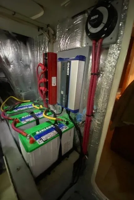 Slide: The Image of Battery compartment of a 2002 Silverton 453 Motor Yacht with wiring and equipment. - 32