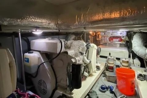 Slide: The Image of Engine room of a 2002 Silverton 453 Motor Yacht, featuring machinery and maintenance tools. - 34