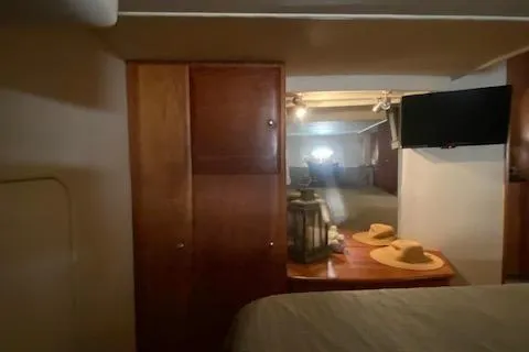 Slide: The Image of Interior of 2002 Silverton 453 Motor Yacht with wood cabinetry and mounted TV. - 35