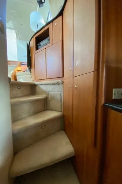 Slide: The Image of Interior stairs of 2002 Silverton 453 Motor Yacht with wooden cabinets. - 41