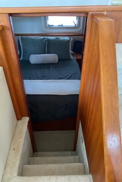 Slide: The Image of Interior view of 2002 Silverton 453 Motor Yacht bedroom with stairs and window. - 43