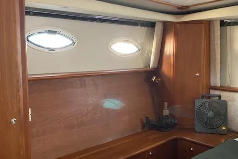 Slide: The Image of Interior cabin of 2002 Silverton 453 Motor Yacht with wooden paneling and porthole windows. - 45