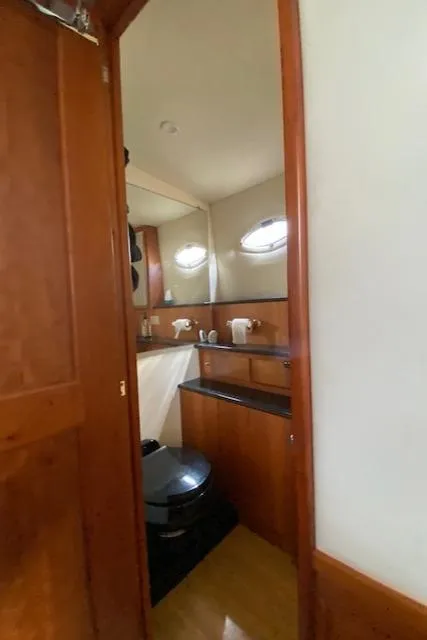 Slide: The Image of 2002 Silverton 453 Motor Yacht bathroom with wooden cabinetry and modern fixtures. - 47