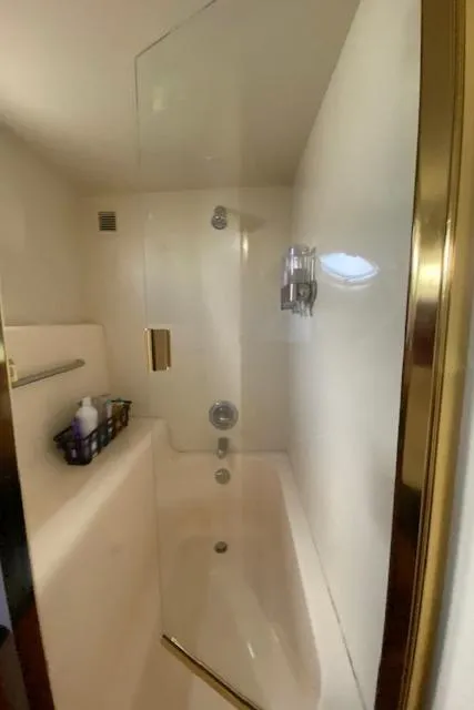 Slide: The Image of Bathroom shower in 2002 Silverton 453 Motor Yacht with glass door and gold trim. - 49