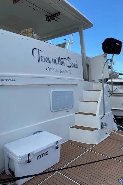 Slide: The Image of 2002 Silverton 453 Motor Yacht docked, featuring "Toes in the Sand" text and RTIC cooler. - 6