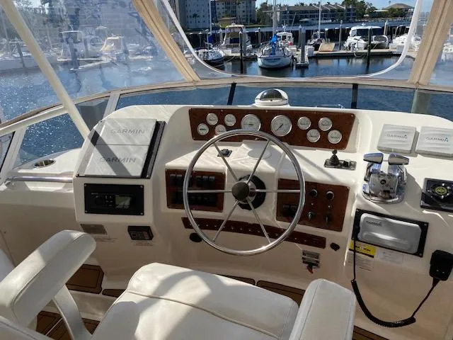 Slide: The Image of Helm of 2002 Silverton 453 Motor Yacht with marina view. - 9