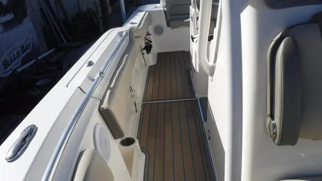 Slide: The Image of 2021 Key West 263FS boat interior with sleek seating and wood-style flooring. - 13