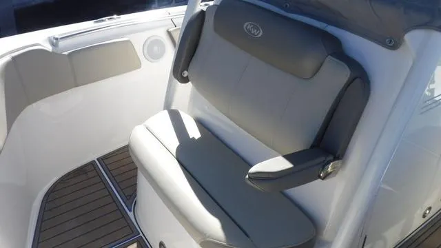 Slide: The Image of 2021 Key West 263FS boat seat with gray upholstery and armrests. - 15