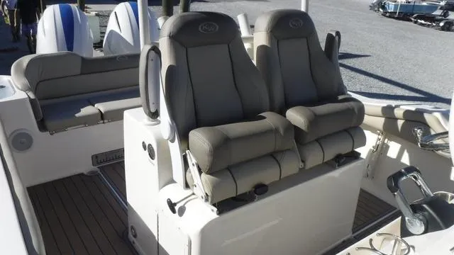 Slide: The Image of 2021 Key West 263FS boat interior with dual cushioned seats and deck view. - 16