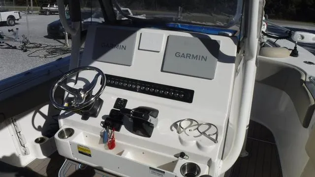 Slide: The Image of 2021 Key West 263FS boat dashboard with Garmin displays and steering wheel. - 17