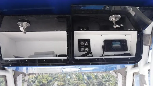 Slide: The Image of 2021 Key West 263FS boat dashboard with storage compartments and electronic controls. - 18