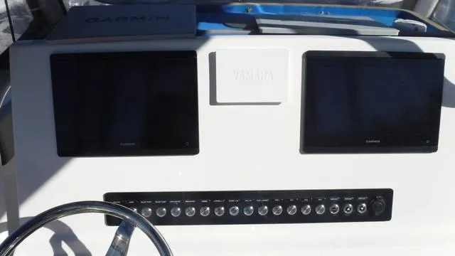 Slide: The Image of Dashboard of 2021 Key West 263FS boat with Garmin displays and Yamaha controls. - 19